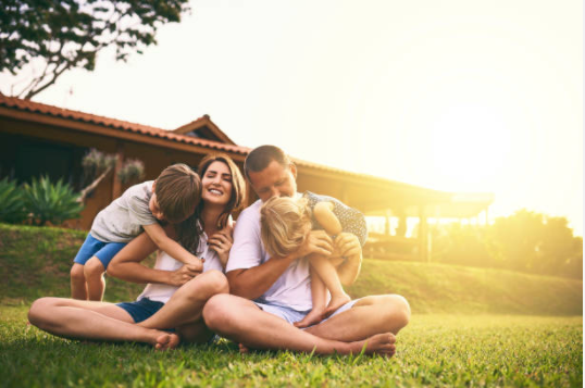 Family with wood fence in background